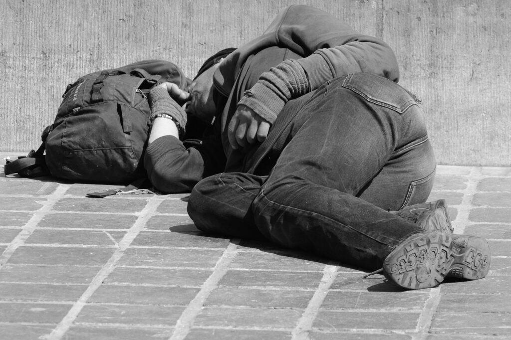 A man lying on the ground with a backpack, possibly experiencing an epilepsy attack. Possible need to be treated with medical marijuana for epilepsy or seizure disorder at Zen Cannabis Clinic.