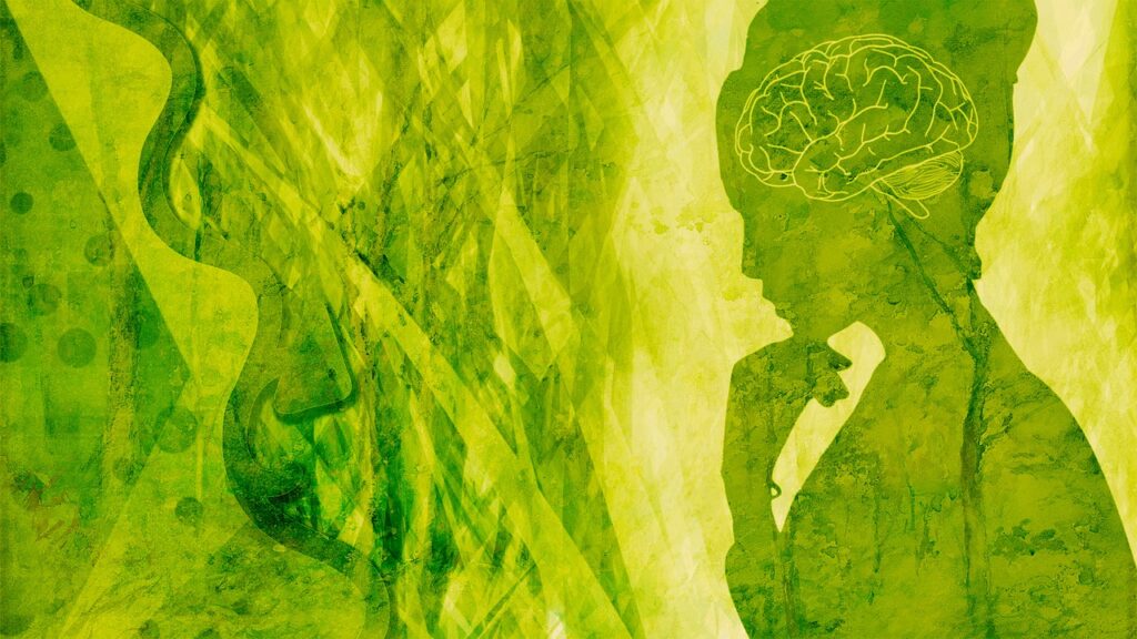 a green and yellow background with a silhouette of a woman symbolizing the connection between the mind and the benefits of medical cannabis for PTSD